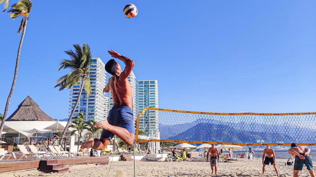 Action-packed beach volleyball match under clear blue skies in Puerto Vallarta.